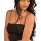 Woman wearing a black top and light blue jeans on a white background