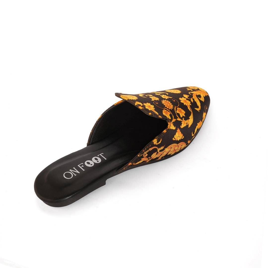 Mule shoe with floral pattern on a white background