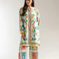 Woman wearing a colorful traditional outfit with a white background