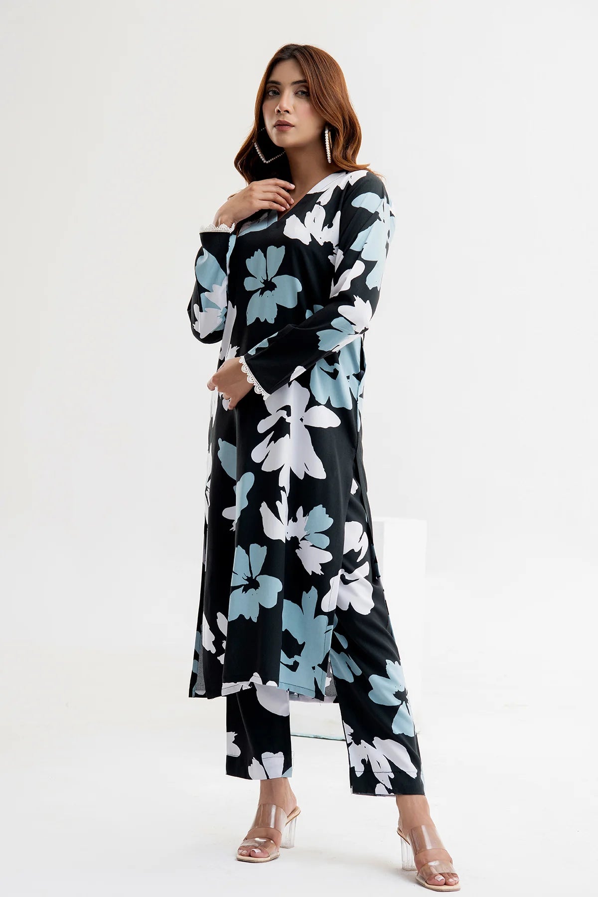 Woman wearing a black floral dress on a white background