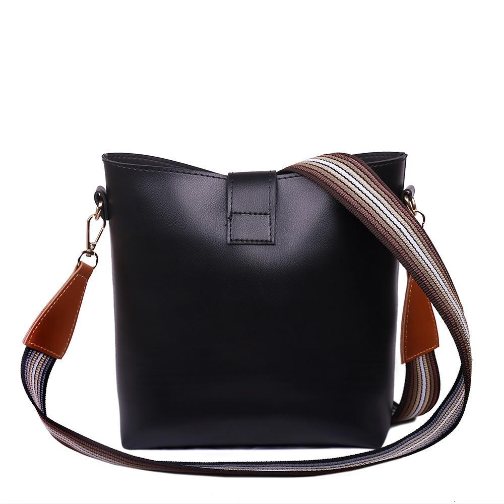 Black handbag with a striped strap on a white background