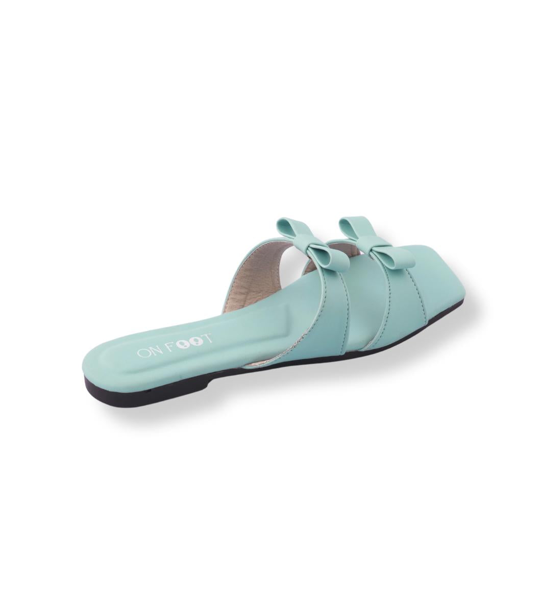 Light blue sandal with a bow on a white background