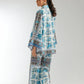 Woman wearing a blue and white patterned outfit on a plain background