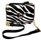 Zebra print handbag with a pearl-like button on a white background