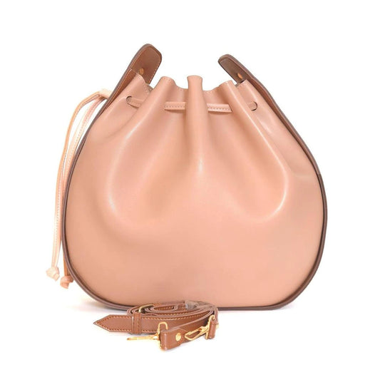 Beige leather handbag with brown strap on a white background