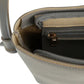 Close-up of a gray handbag with gold zipper and strap.