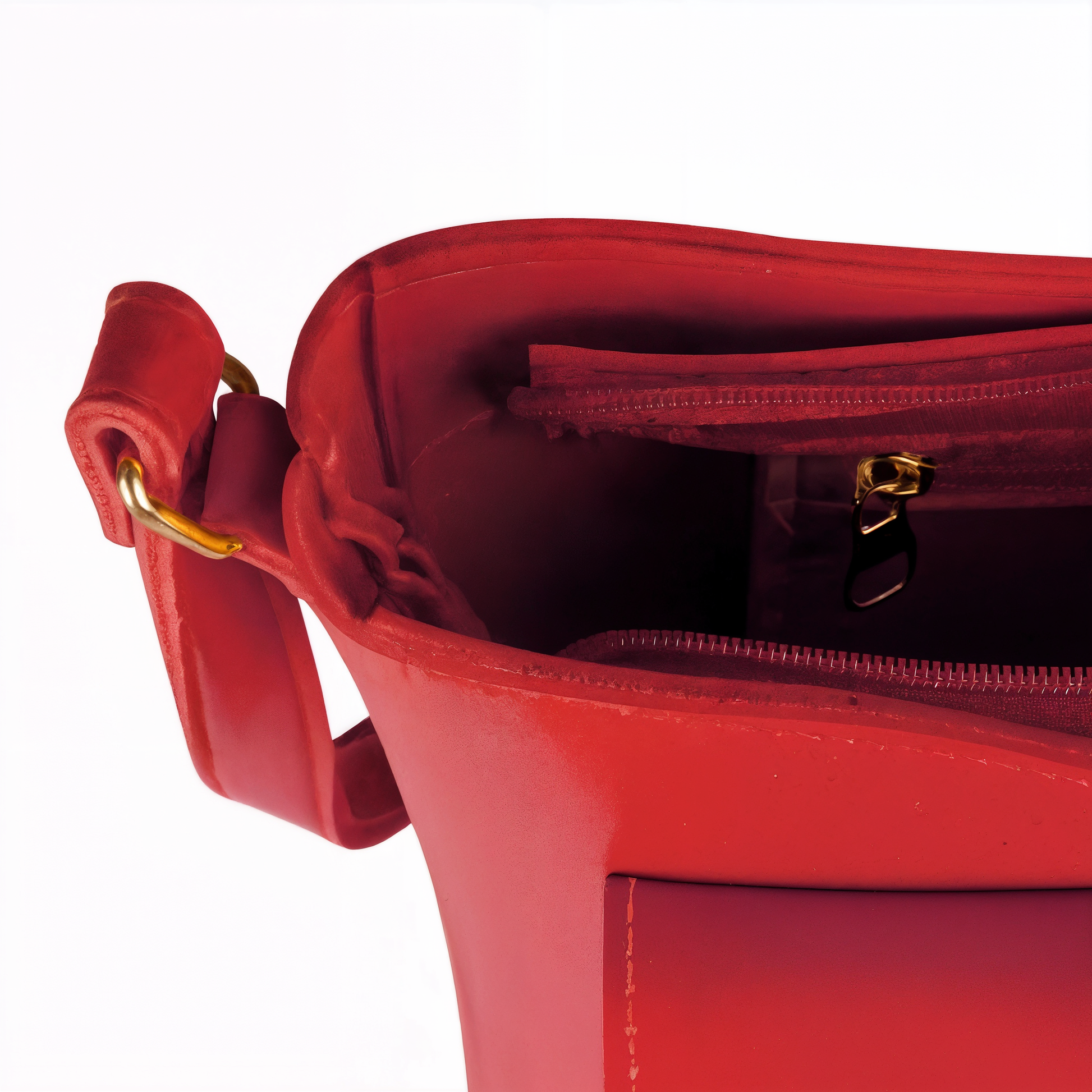 Red handbag with gold zipper and handle on a white background