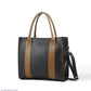 Black handbag with brown accents on a white background