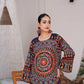 Woman wearing a colorful patterned top in an indoor setting