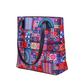 Colorful patterned handbag with black handles on a white background