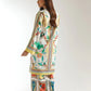 Woman wearing a colorful patterned dress on a white background