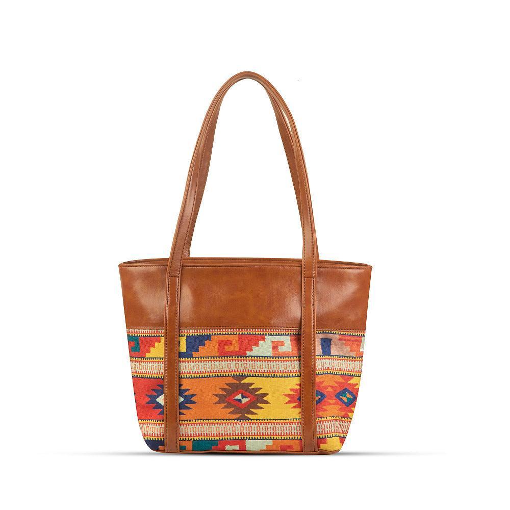 Brown tote bag with colorful patterned bottom section on a white background