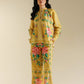 Woman wearing a yellow floral outfit against a beige background
